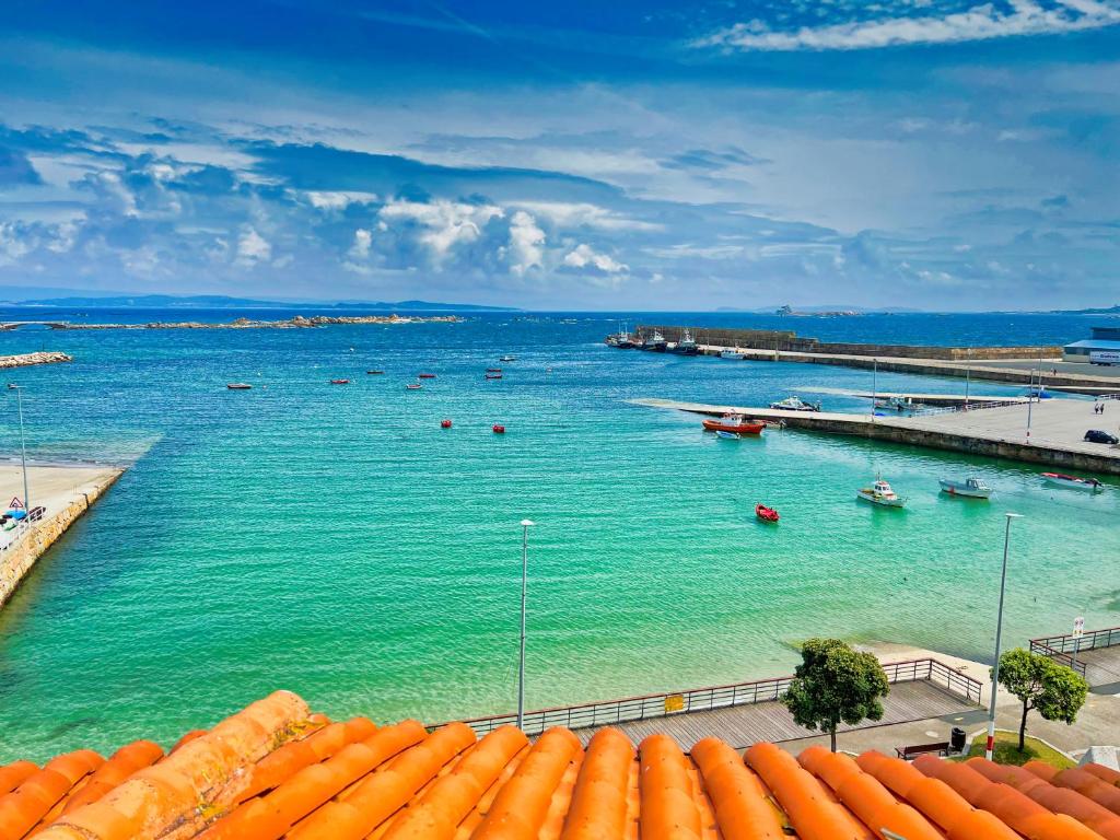a view of a harbor with boats in the water at Illas Atlánticas Ático in Ribeira