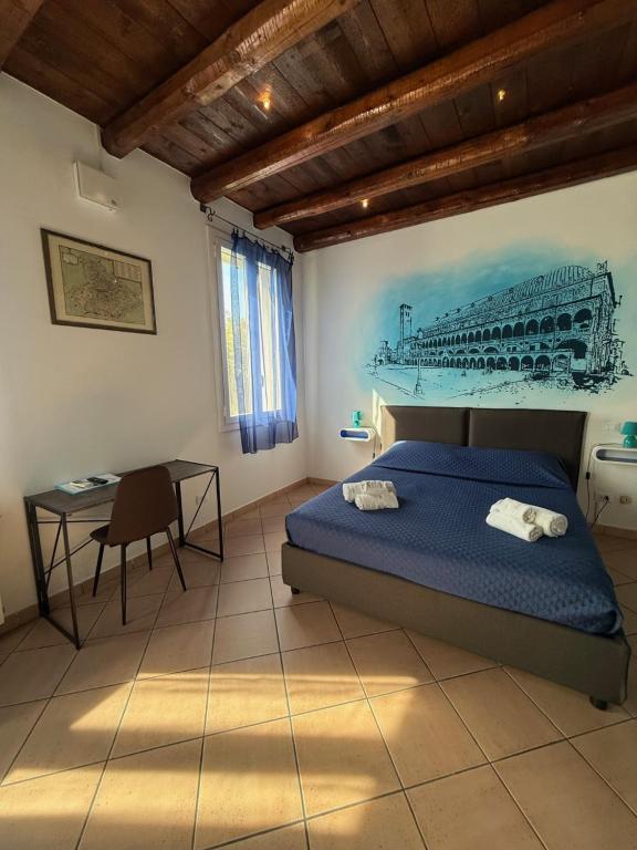 a bedroom with a bed and a table in it at Villetta Emi in Padova
