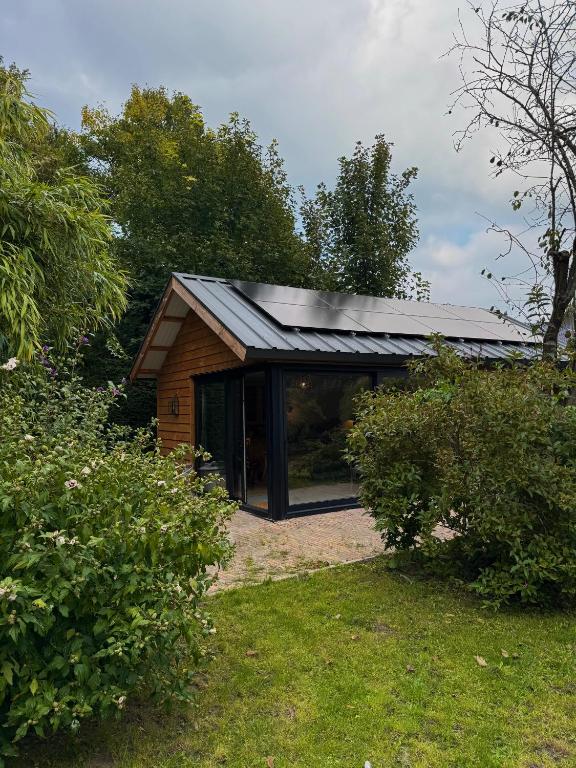 a house with a metal roof on top of it at B&B Molenweg in Laren