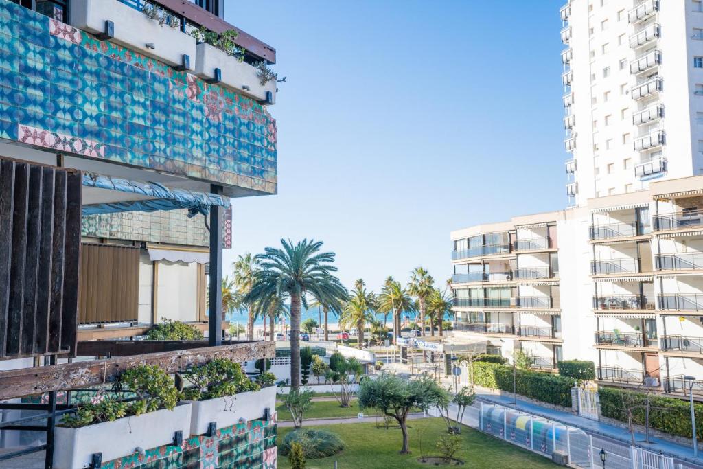 a view of a city with palm trees and buildings at FORMENTOR Apartment in Salou