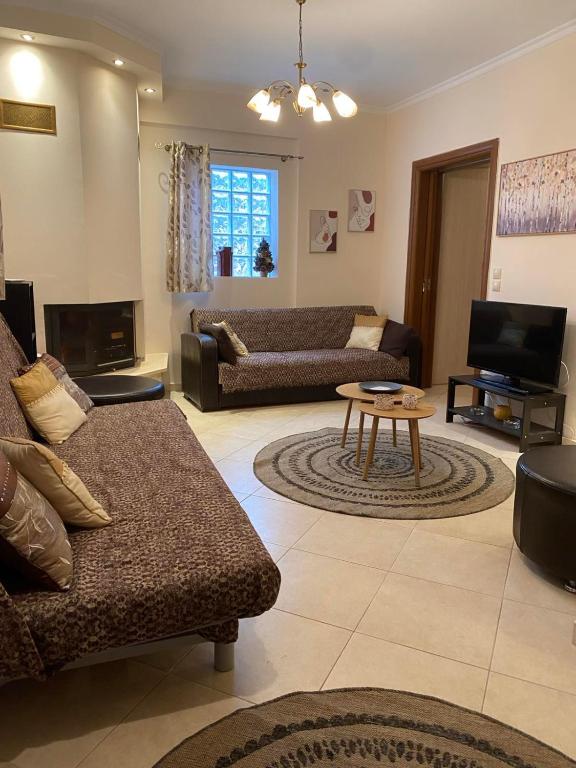 a living room with a couch and a table at Forest Breeze-1 - JM Rentals in Steni Dirfyos