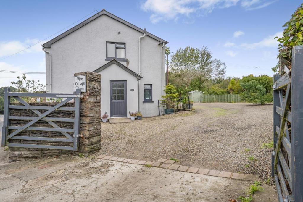 a white house with a gate and a fence at 1 Bed in Saundersfoot oc-t33404 in Kilgetty
