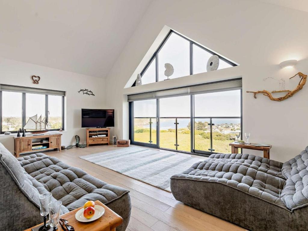 a living room with two couches and a large window at 2 Bed in Helston oc-s33457 in Ruan Major