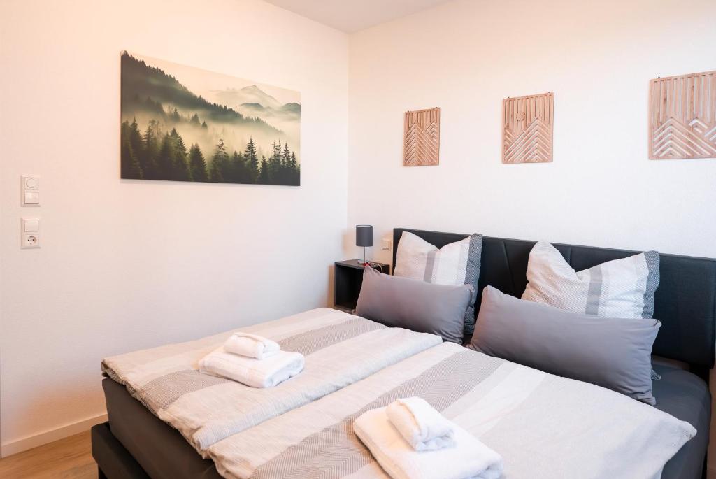 a bedroom with a large bed with towels on it at Corner 28 in Oberkirch
