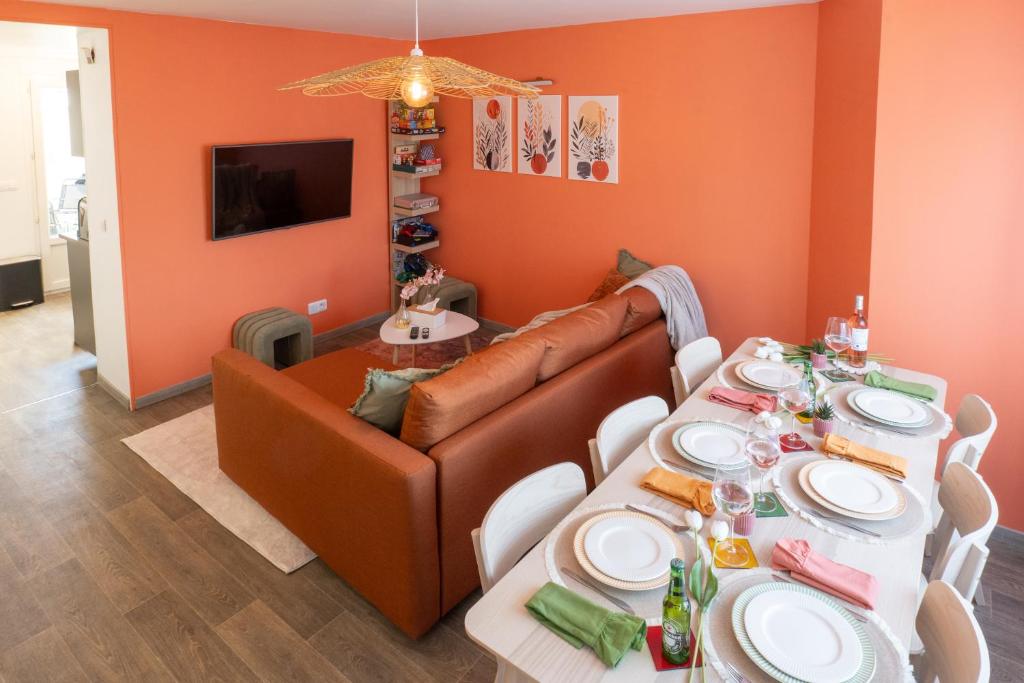 a living room with a couch and a table at La maison du jeu cnpe hypercentre plage 8pers jeux video et de société in Gravelines