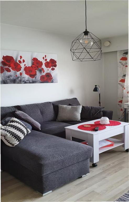 a living room with a couch and a table at Studio with sauna in the center in Laitila