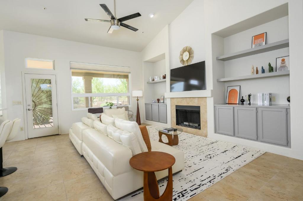 a living room with a white couch and a fireplace at Echo Ridge home in Scottsdale
