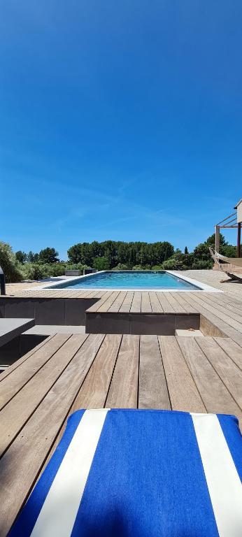 a blue and white rug on a wooden deck at Chambre indépendante vue vignes et mer in Saint-Cyr-sur-Mer