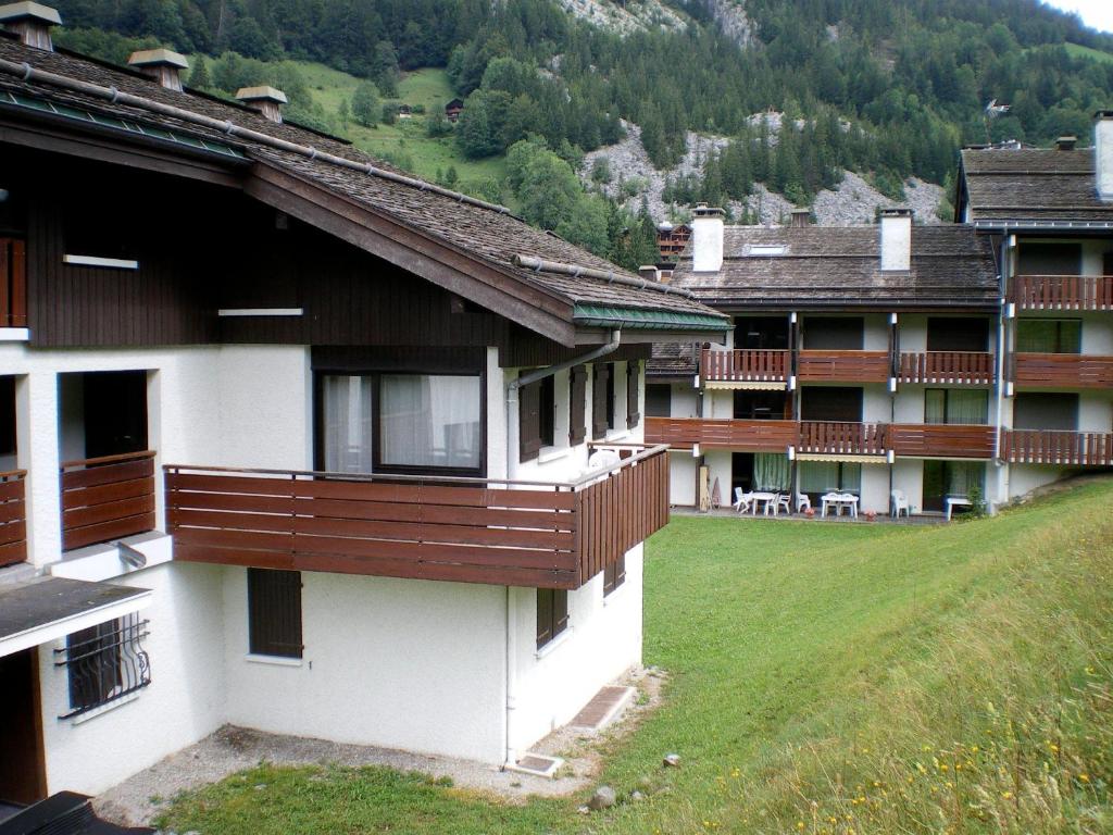 a building with wooden balconies on the side of it at Aigles 19 Bajeux Bât 2 in La Clusaz