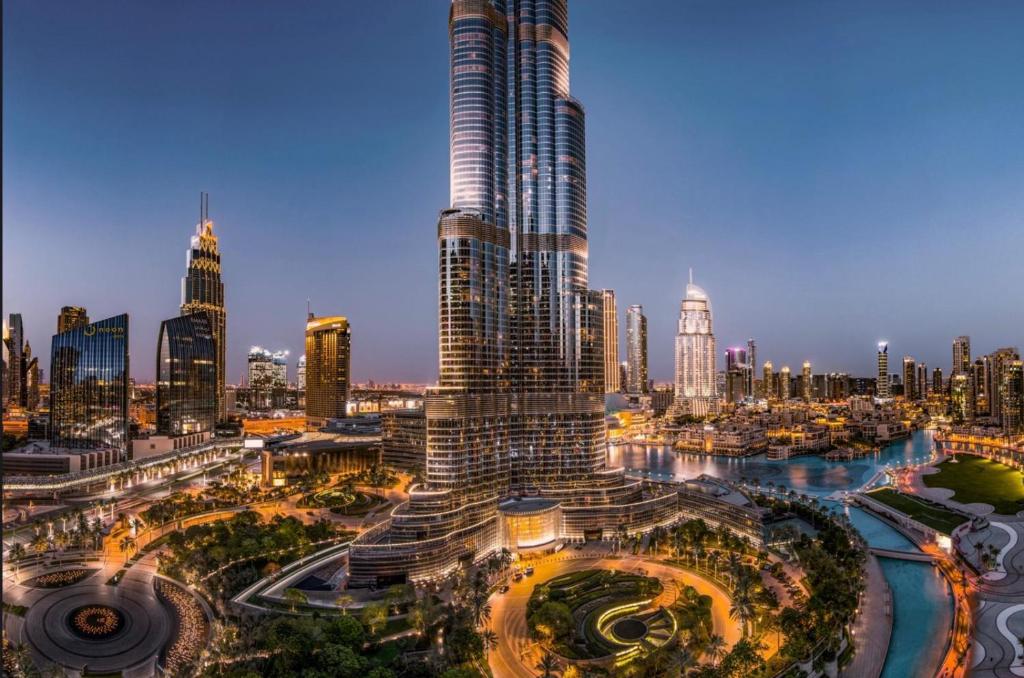 a view of a city with a tall skyscraper at GRANDE RESIDENCES with a direct Burj Khalifa view and Private Fountain Show at 31st floor with DXB AIRPORT VIP Shuttle in Dubai