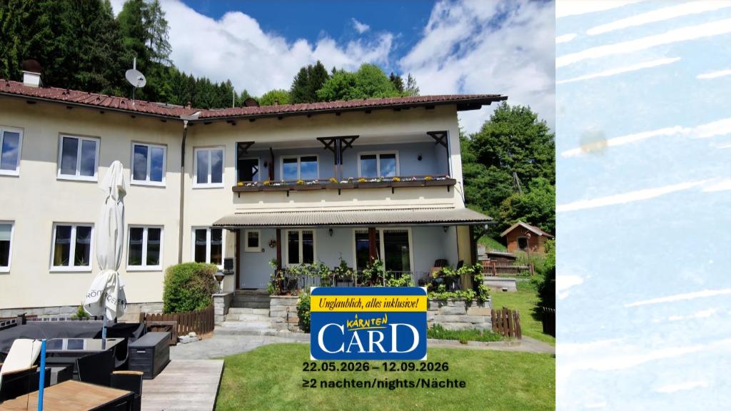 a house with a yard card sign in front of it at Pension Sonnenheim inkl ZomerKärntenCard in Gmünd in Kärnten