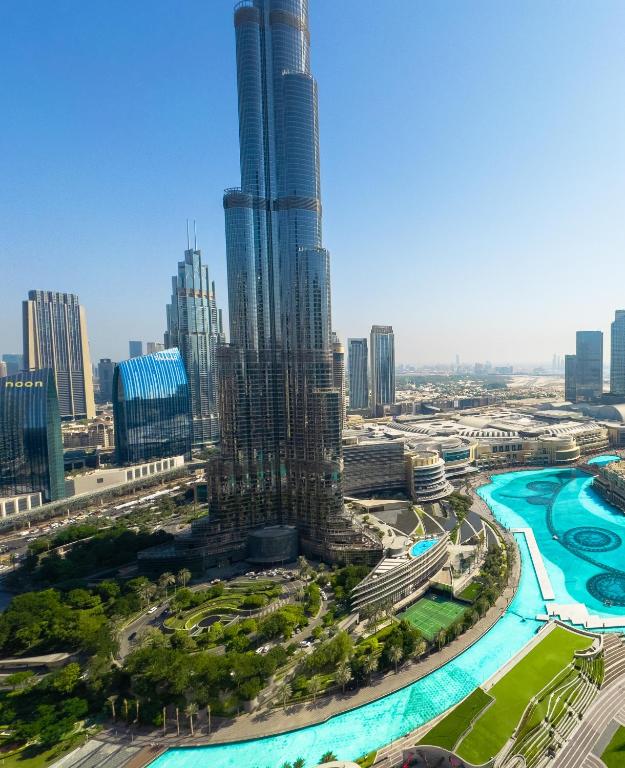 Hotel GRANDE RESIDENCES with a direct Burj Khalifa view and Private Fountain Show at 42nd floor with DXB AIRPORT VIP Shuttle, an aerial view of a city with a tall skyscraper at GRANDE RESIDENCES with a direct Burj Khalifa view and Private Fountain Show at 42nd floor with DXB AIRPORT VIP Shuttle in Dubai