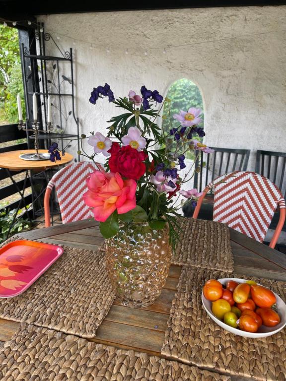 a vase filled with flowers sitting on a table at Gunilla's house in Huaröd in Huaröd