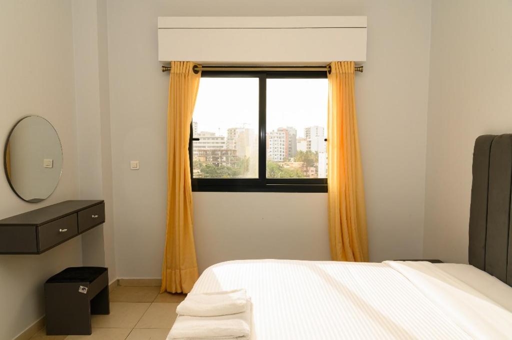a bedroom with a bed and a window at Spacious & bright bedroom in Dakar