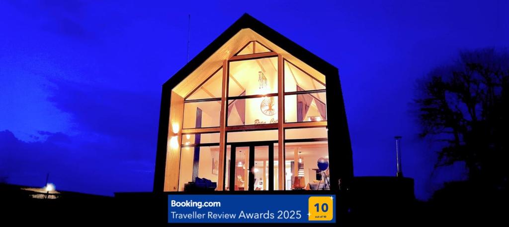 a building with a clock in the window at night at Bran Cottage in Bran