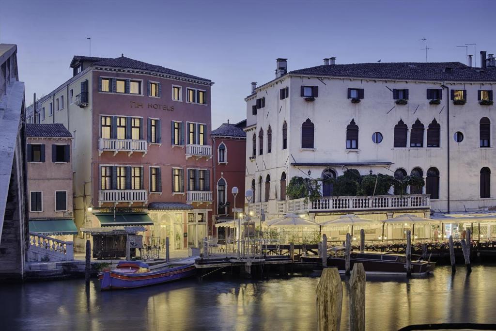 a group of buildings next to a body of water at NH Venezia Santa Lucia in Venice