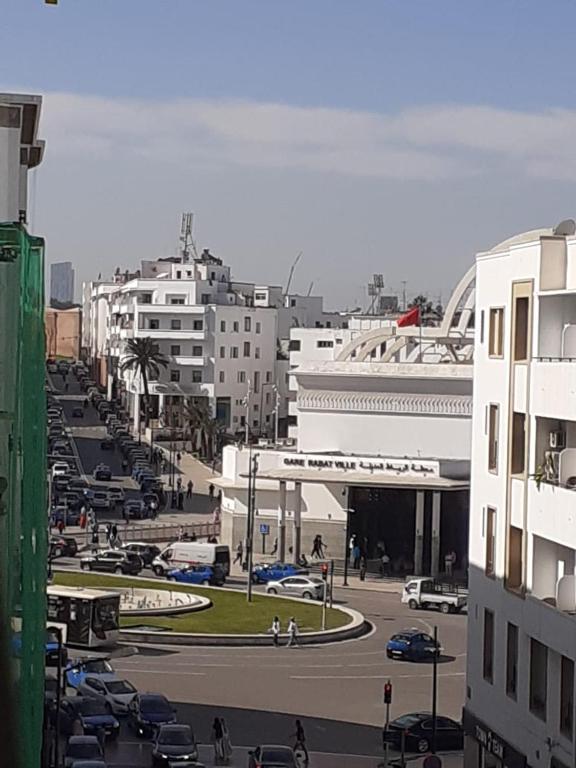 a city with cars parked in a parking lot at Chambre au centre de Rabat in Rabat
