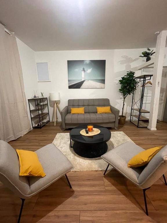 a living room with a couch and a table at Le Nid du Graverand in Rennes