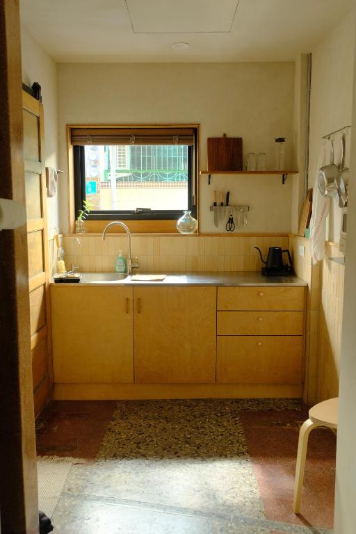 a kitchen with a sink and a window at Tomo 伴 in Tainan