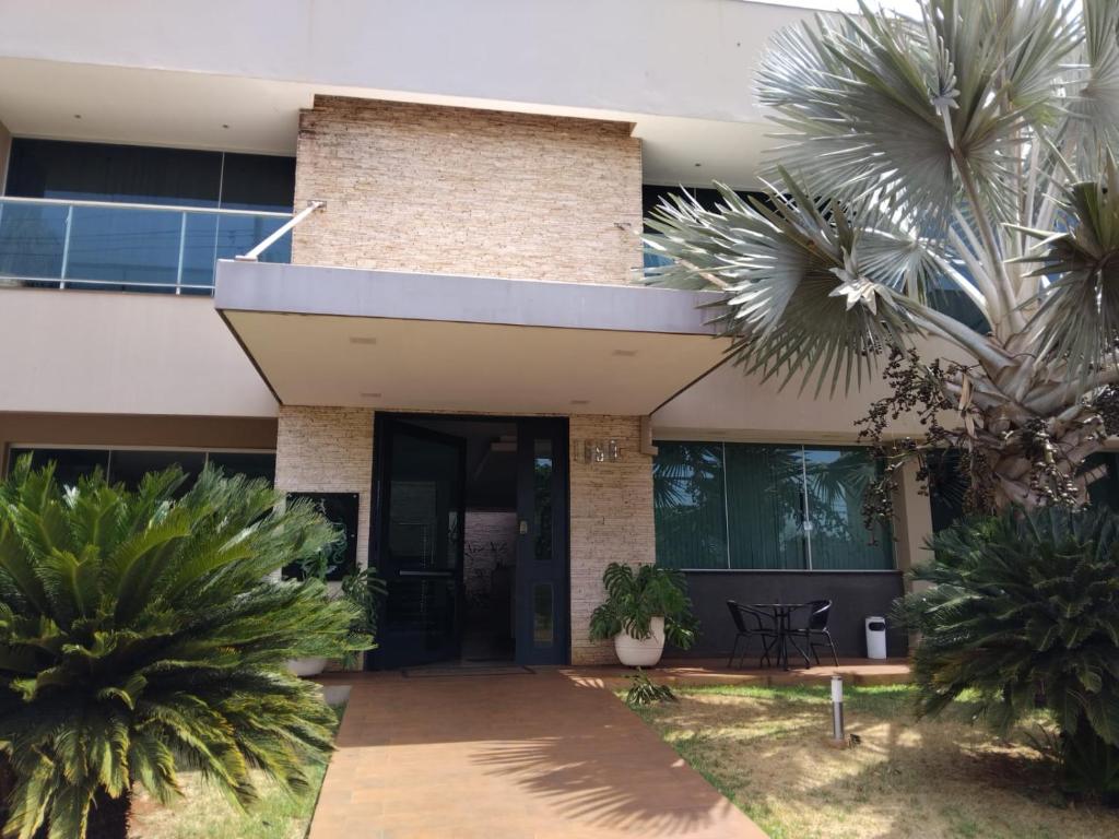 un bâtiment avec des palmiers devant dans l'établissement Palmares Hotel, à Guaíra