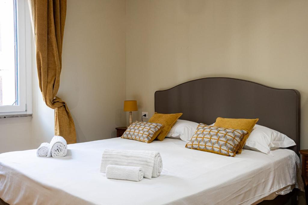a bedroom with a large bed with towels on it at MAMA Luxury in Rome