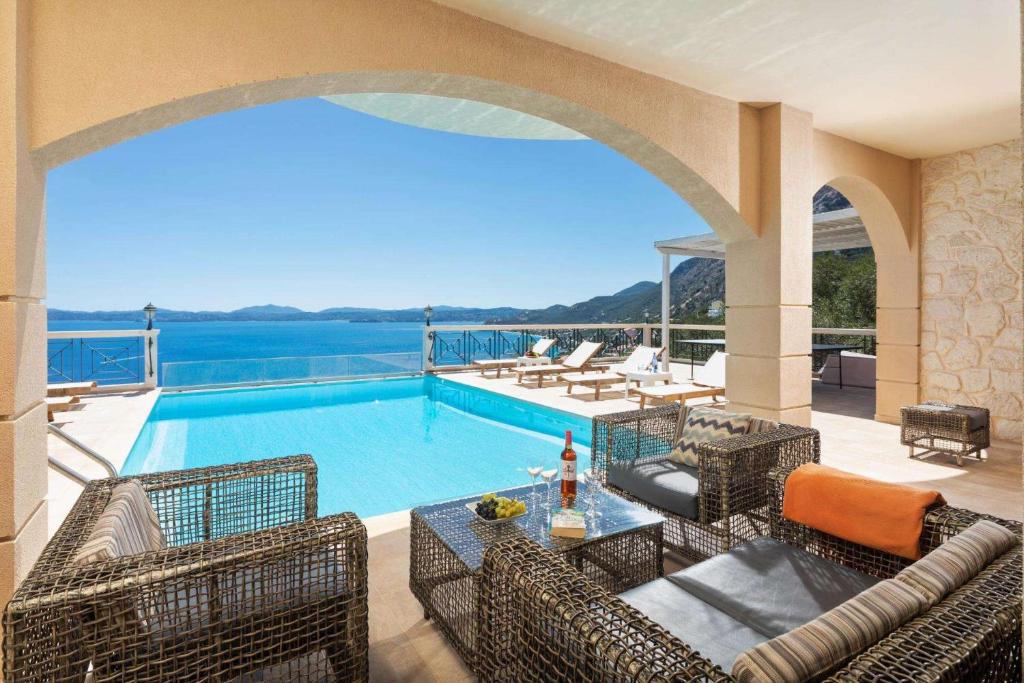 a villa with a swimming pool and a patio at Anna Nissaki in Corfu
