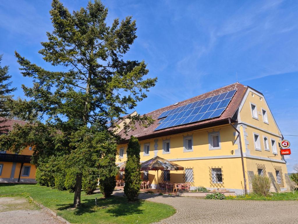 a house with solar panels on the roof at Penzion Ráj in Blíževedly