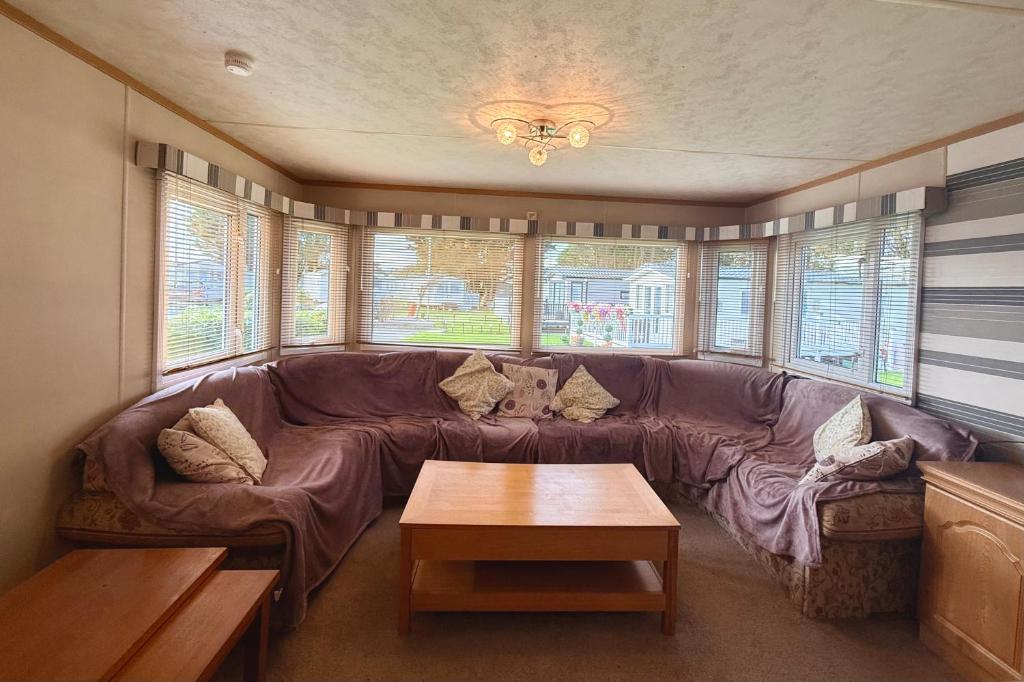 a living room with a couch and a coffee table at The Raven in Silloth