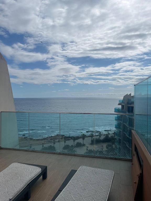 a balcony with a view of the ocean from a building at Urbanization with Sea View in Punta Prima