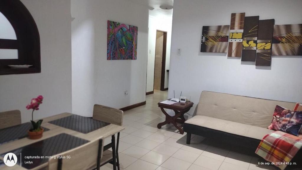 a living room with a couch and a table at Confortable Apartamento in Maracaibo