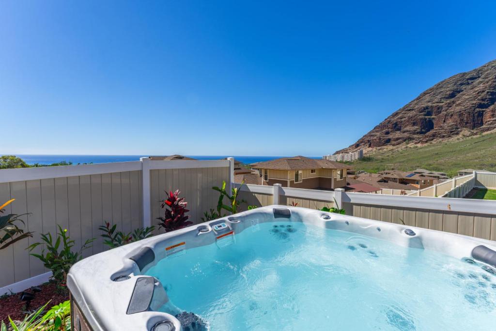 a hot tub in a backyard with a view at Kalo Homes - House of Aloha in Makaha Valley