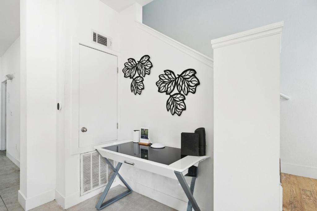 a white room with a desk and butterfly wall decals at Direct resort access Balcony Pool Upgraded Inside in Kissimmee