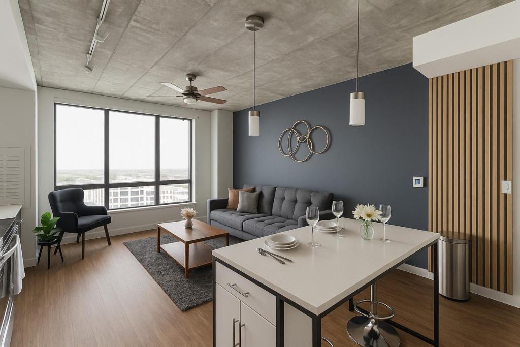 a living room with a couch and a table at Bright 2BR Apt Pool, Gym Walkable Area in Birmingham