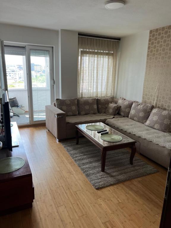 a living room with a couch and a coffee table at Dragodan Star apartman in Pristina
