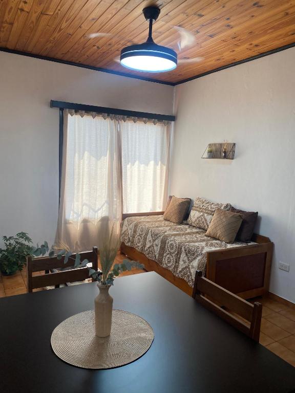 a bedroom with a bed and a table with a vase on it at Julius Apart in Eldorado