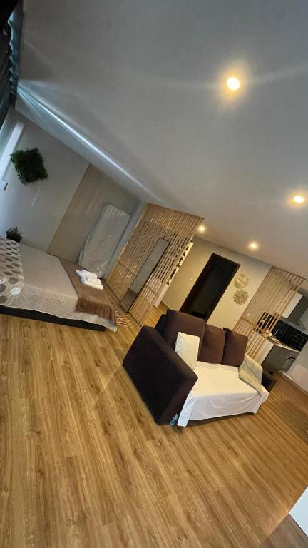 a bedroom with a large bed and a wooden floor at Porto Rio Douro apart in Valbom