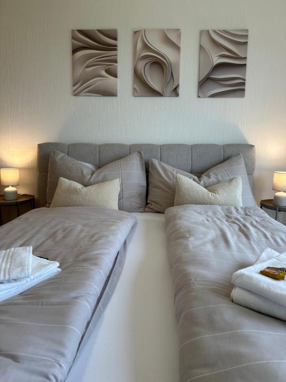 a large white bed with two pillows on it at Bergpanorama, nahe Interlaken 10min Thuner See in Reutigen
