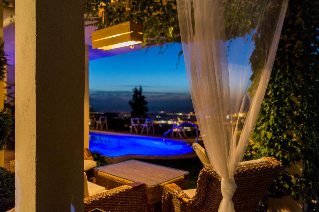 a view of a pool from a patio with a window at El Balcon de las Nieves in La Zubia