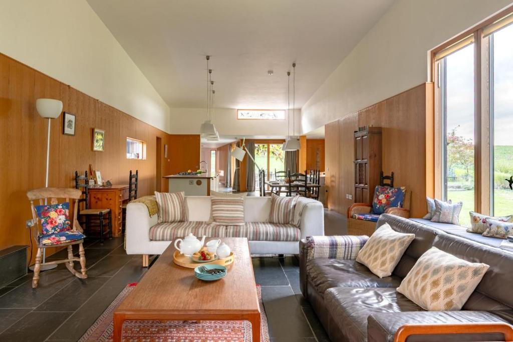 a living room with couches and a table at Glenview in Bramfield