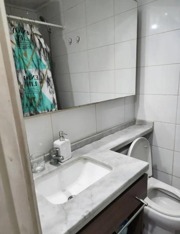 a bathroom with a sink and a toilet at Flor hospedaje in Buenos Aires