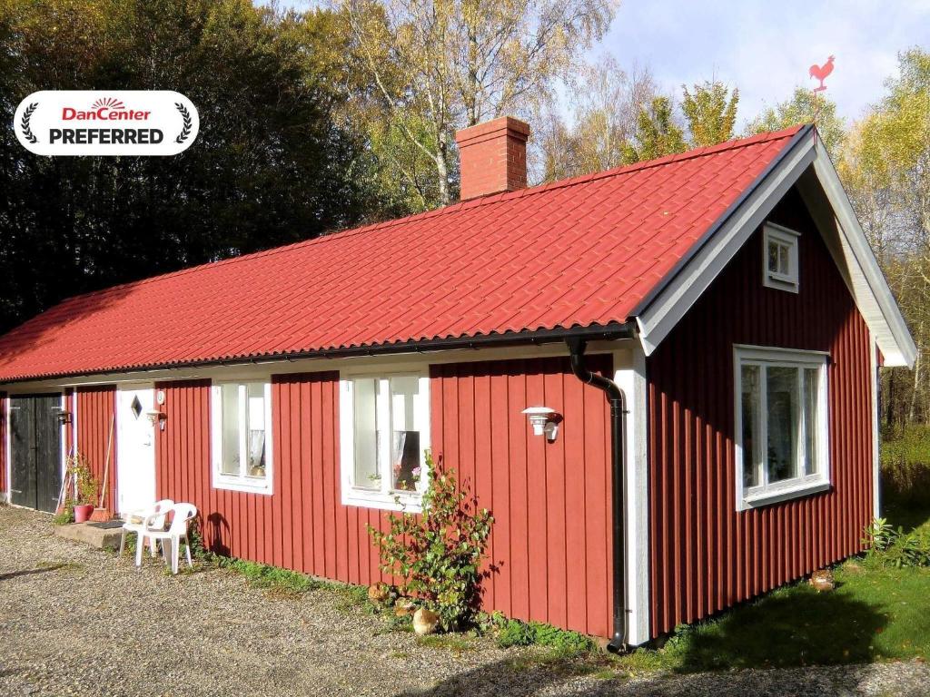 a red shed with a red roof at 4 person holiday home in UNNARYD-By Traum in Unnaryd