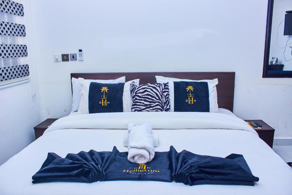 a bedroom with a bed with a towel on it at Heiligtum Des Herrn Hotel in Winneba