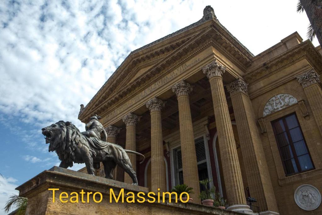 a building with a statue in front of it at Luna di Sicilia in Palermo
