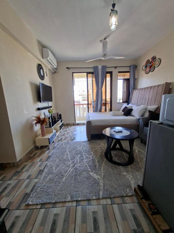 a living room with a couch and a table at Homely studio Apartment 2 in Mombasa