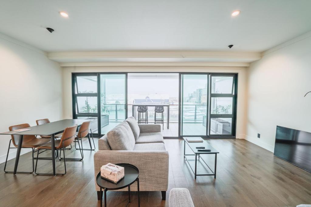 a living room with a couch and a table at Princes Wharf - Spectacular Couple Getaway in Auckland