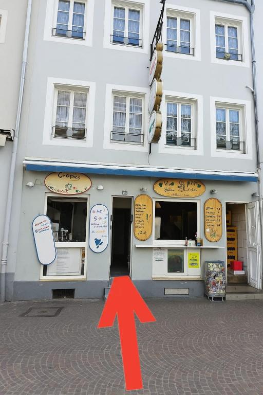a building with a red arrow in front of it at CityHome am Markt in Saarbrücken