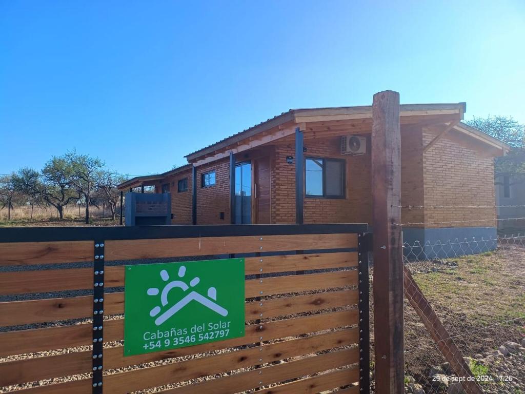 a house with a fence in front of it at Cabanas del Solar in Los Reartes