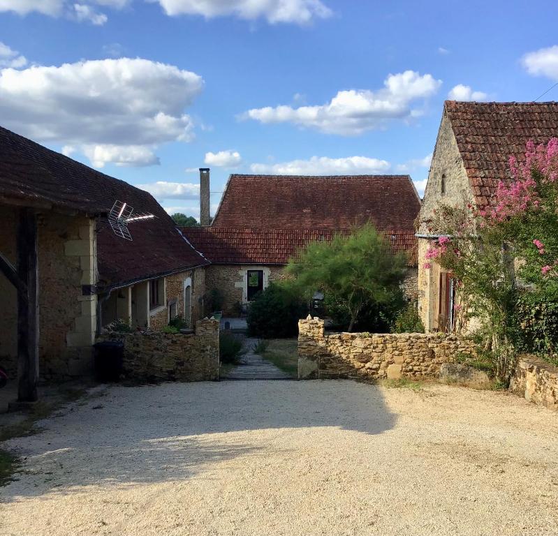 a group of houses in a village with a driveway at Les Gîtes de Leymandie in Saint-Avit-de-Vialard
