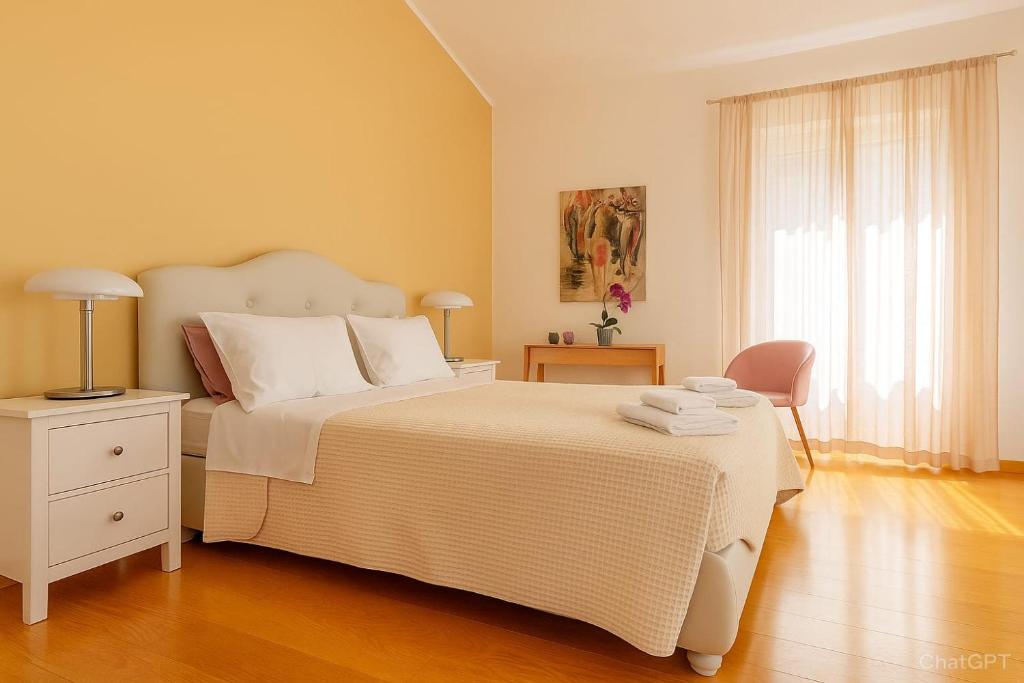 a bedroom with a large white bed and a window at Calogiuri Nest in Lecce