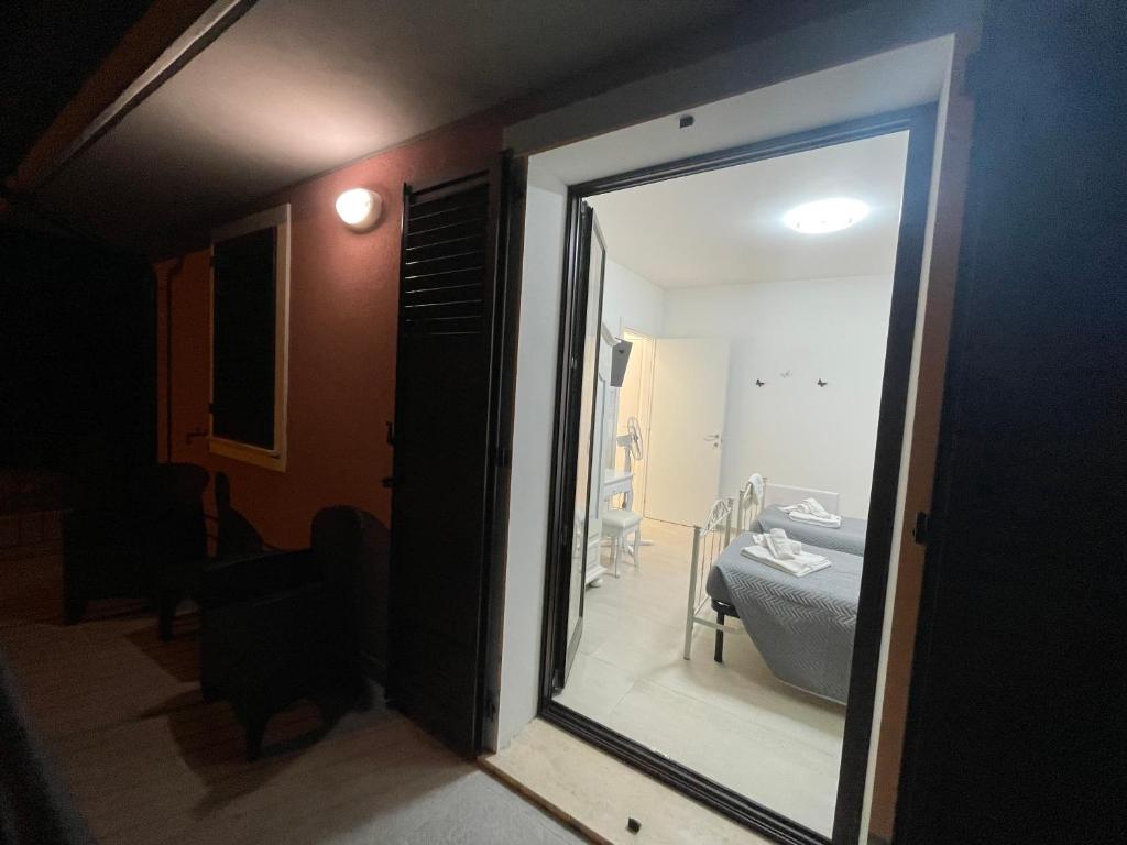 a room with a door to a bedroom with a mirror at CASA NINA Appartamento 1 in Camerino